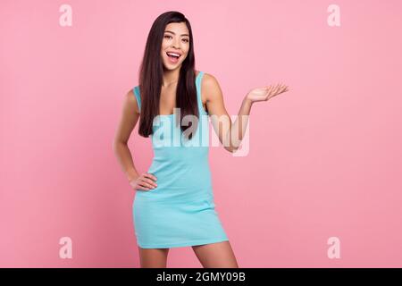 Photo of cute young long hairdo lady stand talk wear blue dress isolated on pastel pink color background Stock Photo