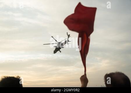 Izmir, Turkey - September 9, 2021: Turkish Atak Police Helicopter and a Turkish flag in the same frame on the celebrations of liberation day of Izmir Stock Photo