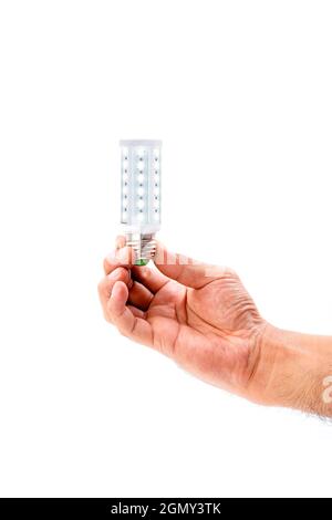 Human hand holding LED light bulb isolated on white background. Stock Photo