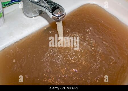 Low quality of tap water. The reason why it makes sense to install tap water filter. Stock Photo