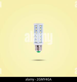LED energy saving lamp 230v isolated on yellow pastel color background. Stock Photo