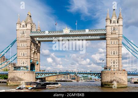 An Uber Boat On The River Thames With Tower Bridge As A Backdrop, London, UK. Stock Photo