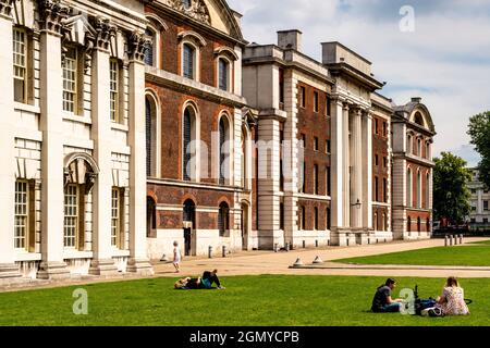 Young People Sitting In The Gardens At The Old Royal Navy College, Greenwich, London, UK. Stock Photo