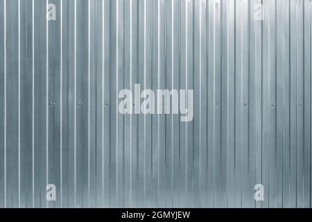 Gray corrugated metal fence background. Stock Photo