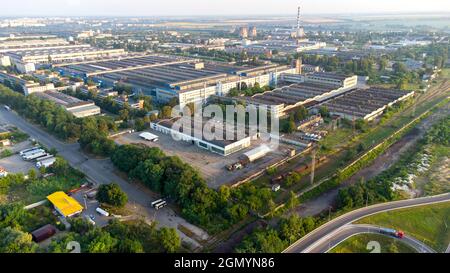 Aerial drone view flight over industrial zone on summer morning. Stock Photo