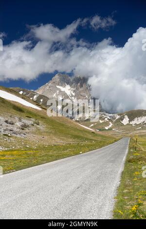 Mountain Landscape, view of the Corno Grande with a road in the foreground, Abruzzo, Italy Stock Photo