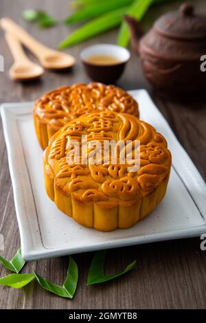 Moon cakes with Chinese tea. The Chinese character on the mooncake represent 'Pandan lotus paste with single york' in English Stock Photo