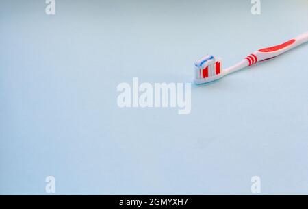 red toothbrush with blue Toothpaste Stock Photo