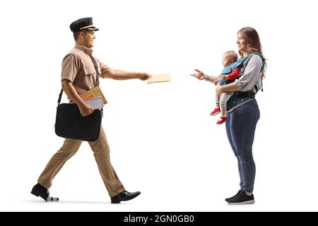 Full length profile shot of a mailman delivering letter to a mother with a baby isolated on white background Stock Photo