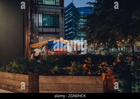 London, UK - September 03, 2021: View over the planters of Aperol Spritzeria Truck outside Eataly Italian food market in Broadgate that includes resta Stock Photo