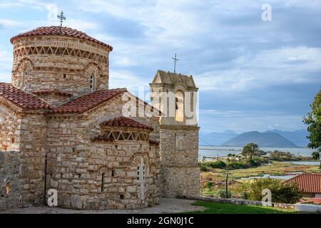 The little 10th cen. Byzantine church of  Panagia Koronisias in the village of Koronisia on Koronisia island with the Ambracian Gulf in the background Stock Photo