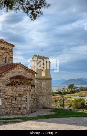 The little 10th cen. Byzantine church of  Panagia Koronisias in the village of Koronisia on Koronisia island with the Ambracian Gulf in the background Stock Photo