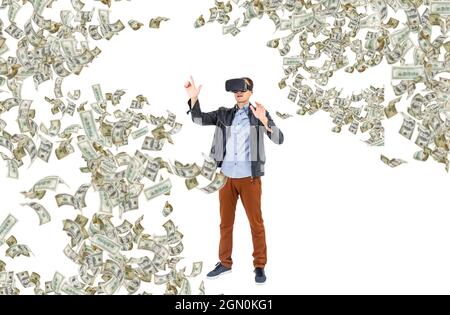 Dollar banknotes flying around young man wearing virtual reality glasses, Virtual reality concept. Stock Photo