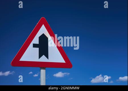 detail of a crossroads sign with priority over blue sky Stock Photo