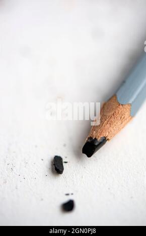 Pencil with broken lead on a sheet of white paper Stock Photo
