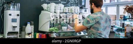 Male barista preparing coffee machine Stock Photo