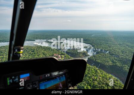 Aerial view of the waterfalls at Iguazu Falls seen through the window of a helicopter with cockpit instruments in the foreground, Iguazu National Park Stock Photo