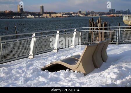 The sunbeds in the winter over the snow on Riverside park in New York City Stock Photo