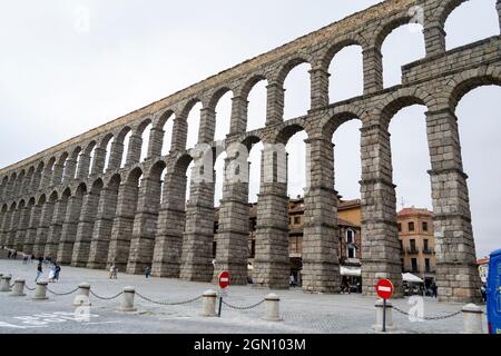 SEGOVIA SPAIN - SEPTEMBER 21, 2021. Aqueduct of Segovia. Ancient Roman aqueduct in the Plaza del Azoguejo and old construction cities in Segovia. Stock Photo