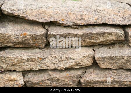 Close-up of a detailed picture of a stone wall. Old stone wall texture background for design and decor. High quality photo Stock Photo