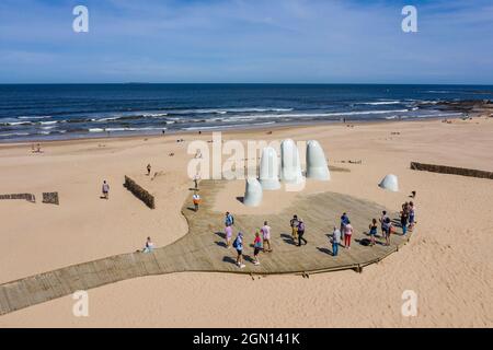 Aerial view of visitors at the sculpture La Mano (The Hand) by Chilean artist Mario Irarrázaba on the beach, Punta del Este, Maldonado Department, Uru Stock Photo