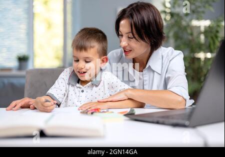 Mother helping son with homework Stock Photo
