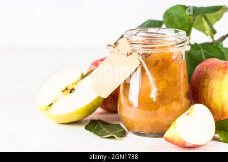 Apple jam with fresh apples on white background. Stock Photo