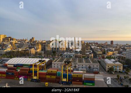 Aerial view of freight containers on pier with city skyline at sunrise, Montevideo, Montevideo Department, Uruguay, South America Stock Photo