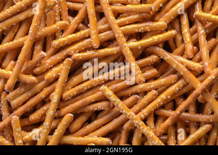 Pile of Pretzel Sticks Background Texture Close Up. Stock Photo