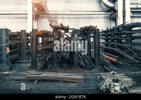 Steel pipes bunch on rack in metallurgical factory or plant warehouse. Stock Photo