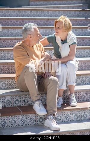 Romantic married couple sitting on the patterned steps Stock Photo