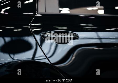 exterior door handle of car. Latch and lock. Black body. Stock Photo