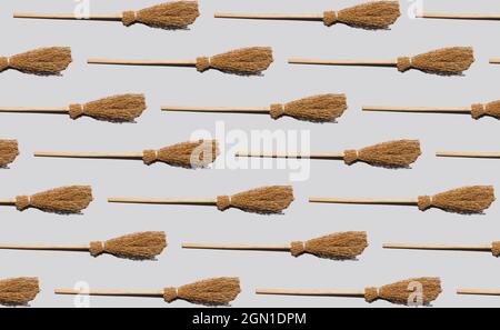 Witch broomstick with shadow, seamless pattern on bright grey background. Minimal abstract Halloween and season specific concept. Flat lay. Top view. Stock Photo