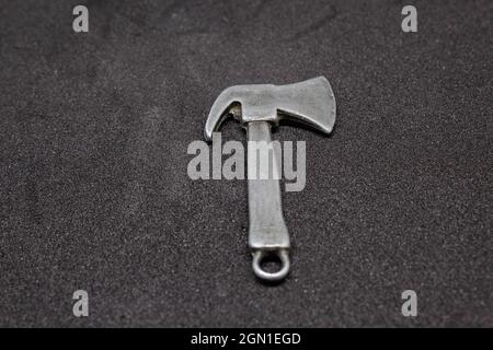 Small axe for a keychain. an axe is one of the most basic tools. primitive but effective. Stock Photo