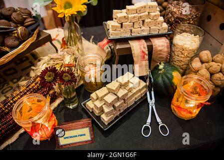 Fall festive food spread with fudge flowers and colorful leaf decor. Top view Stock Photo