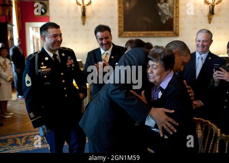 President Barack Obama hugs Bertha Petry, the grandmother of Sergeant First Class Leroy Arthur Petry, U.S. Army, in the Blue Room of the White House, July 12, 2011. The President later awarded SFC Petry, left, the Medal of Honor for his courageous actions during combat operations against an armed enemy in Paktya, Afghanistan, in May 2008. (Official White House Photo by Pete Souza) This official White House photograph is being made available only for publication by news organizations and/or for personal use printing by the subject(s) of the photograph. The photograph may not be manipulated in a Stock Photo