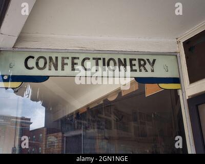 A painted Confectionery sign in a shop window. Stock Photo