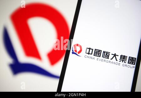 In this photo illustration a China Evergrande Group logo is seen on a smartphone screen. Stock Photo