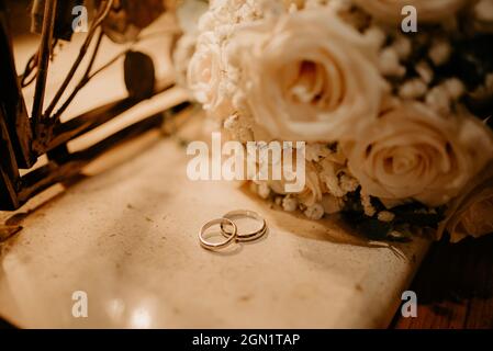 wedding rings and bouquet moody Stock Photo