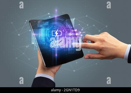 Businessman holding a foldable smartphone, technology concept Stock Photo
