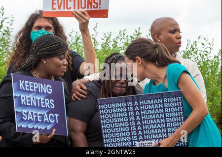 Washington DC, US, 21/09/2021, Vivian Smith, center, of Miami, Florida, cries while being comforted by United States Representative Cori Bush (Democrat of Missouri), left, United States Representative Alexandria Ocasio-Cortez (Democrat of New York), second from right, and United States Representative Ayanna Pressley (Democrat of Massachusetts), right, during a press conference about the Keeping Renters Safe Act of 2021, at the US Capitol in Washington, DC, Tuesday, September 21, 2021. Vivian is a single mother of two children who was evicted last year during the pandemic after her landlord fil Stock Photo