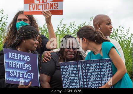 Washington DC, US, 21/09/2021, Vivian Smith, center, of Miami, Florida, cries while being comforted by United States Representative Cori Bush (Democrat of Missouri), left, United States Representative Alexandria Ocasio-Cortez (Democrat of New York), second from right, and United States Representative Ayanna Pressley (Democrat of Massachusetts), right, during a press conference about the Keeping Renters Safe Act of 2021, at the US Capitol in Washington, DC, Tuesday, September 21, 2021. Vivian is a single mother of two children who was evicted last year during the pandemic after her landlord fil Stock Photo