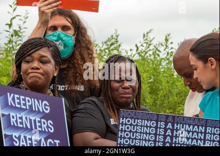 Washington DC, US, 21/09/2021, Vivian Smith, center, of Miami, Florida, cries while being comforted by United States Representative Cori Bush (Democrat of Missouri), left, United States Representative Alexandria Ocasio-Cortez (Democrat of New York), right, and United States Representative Ayanna Pressley (Democrat of Massachusetts), second from right, during a press conference about the Keeping Renters Safe Act of 2021, at the US Capitol in Washington, DC, Tuesday, September 21, 2021. Vivian is a single mother of two children who was evicted last year during the pandemic after her landlord fil Stock Photo