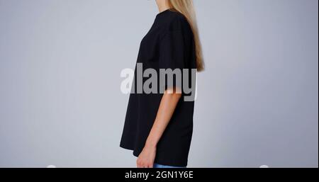 The profile of a woman in black T-shirt Stock Photo