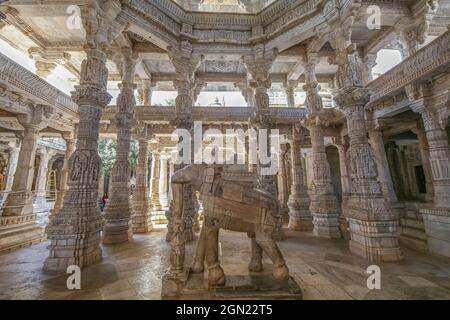 Historic Dilwara Jain temple interior architecture with view of intricately carved stone ceiling with columns with beautiful artwork Stock Photo