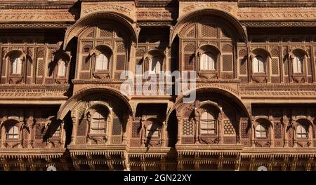 Traditional Rajasthan architecture made of yellow limestone with intricate artwork of heritage building 'Patwon ki haveli' at Jaisalmer India. Stock Photo
