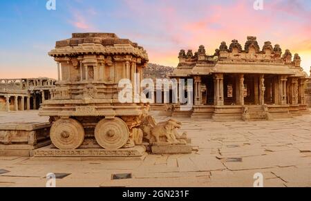 Stone chariot at Hampi with ancient archaeological ruins in the courtyard of Vittala Temple at Karnataka India at sunset Stock Photo