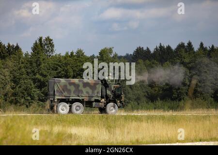 U.S. Army Soldiers from 12th Combat Aviation Brigade operate an M2 .50 caliber machine gun in Grafenwoehr, Germany, on Sep. 18, 2021. The M2 was mounted on an M1083 A1P2 five-ton mobile tactical vehicle, part of the weapon demonstrations during the 12th Combat Aviation Brigade family day. (U.S. Army photo by Sgt. Cory Reese) Stock Photo