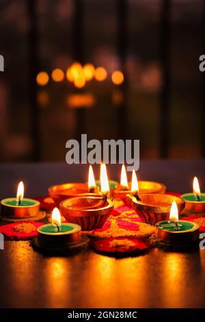 Diwali celebration Indian festival of lights Diya oil lamp and colors Rangoli decoration bright colorful flowers flowerbed copy space Deepavali Stock Photo