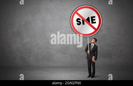 Young business person holdig traffic sign Stock Photo